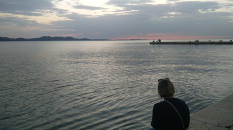 Me sitting along the shore in Old Zadar at sunset
