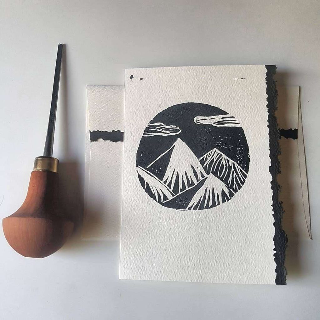 Homemade black and white linocut card of mountains