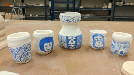 A photo of Sake carafe and glasses in the pottery student at the underglaze phase.