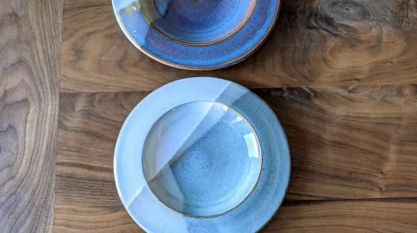 Ceramic Plates in a Row on a Wooden Table