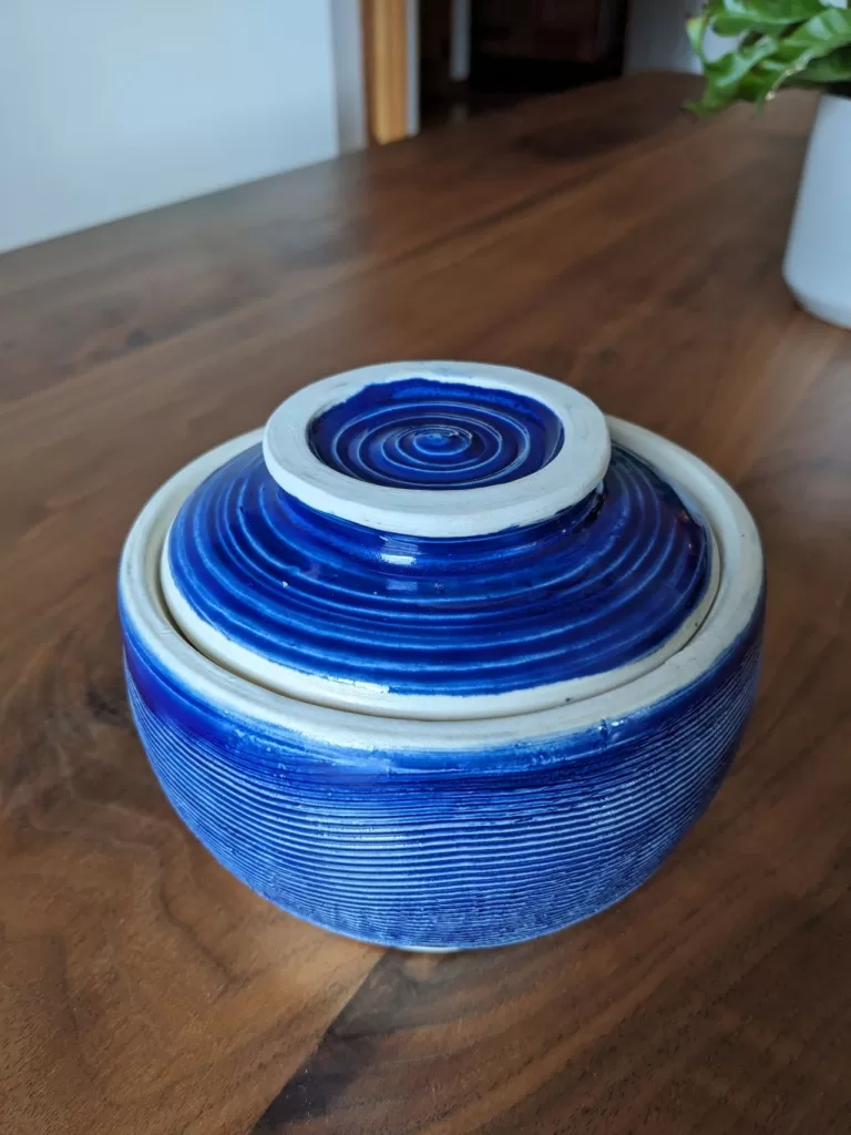 A practical pottery cookie jar in bright cobalt blue.