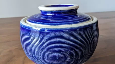 A cobalt blue pottery jar with a practical twist - a lid that also acts as a plate.