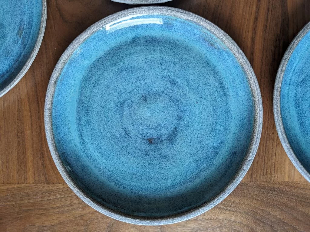 Close up of Mayco Norse Blue on a pottery dinner plate made of granite clay.